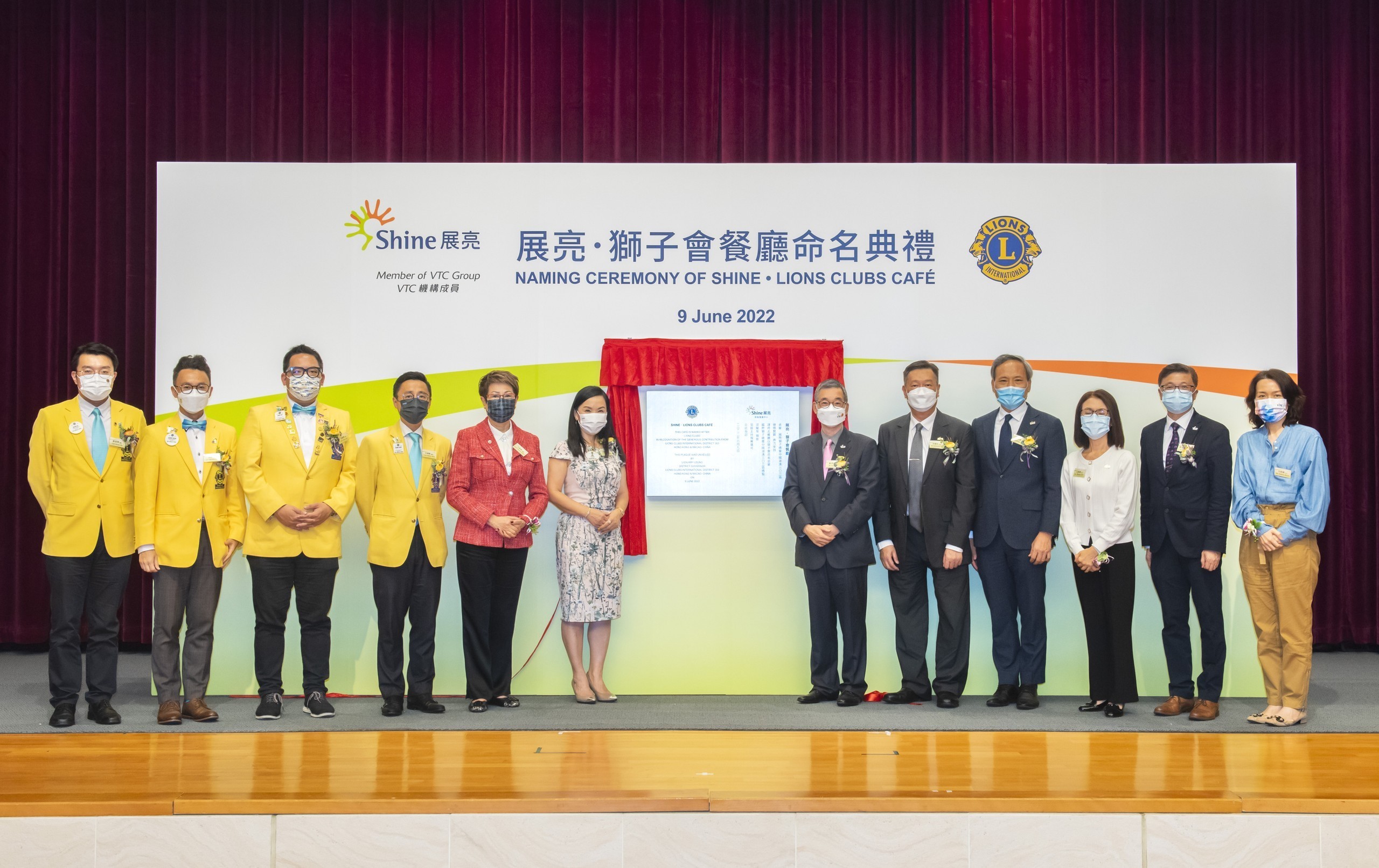 Group photo of guests and Shine's students on stage
